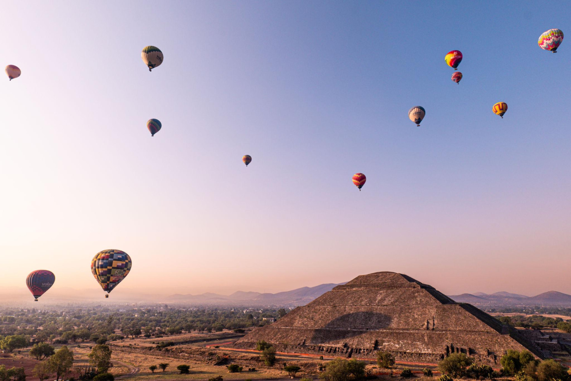 Hot air balloons rising over the Pyramid of the Sun at Teotihuacan